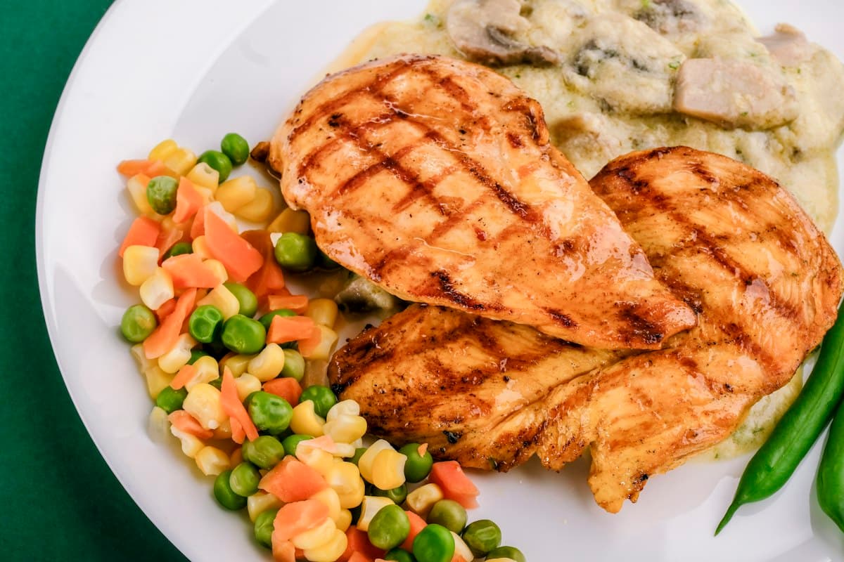 Grilled jerk chicken with rice and vegetables